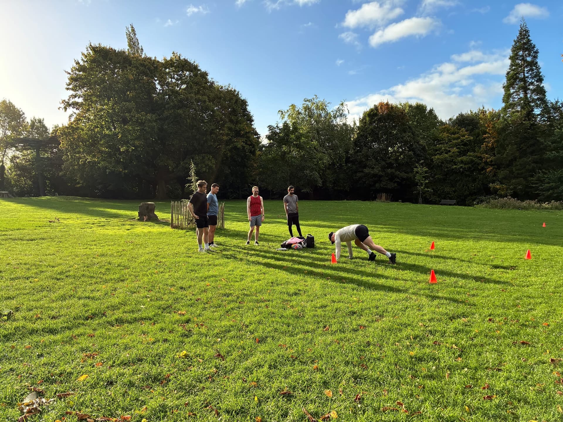 Group warming up on the grass before a morning of park games.