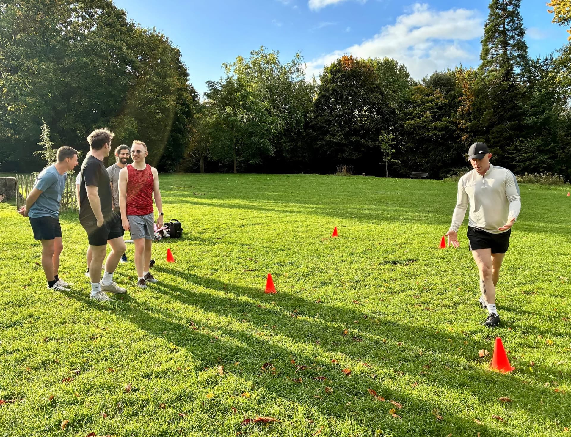 Mid-game on the grass, one holding a plank as others watch.