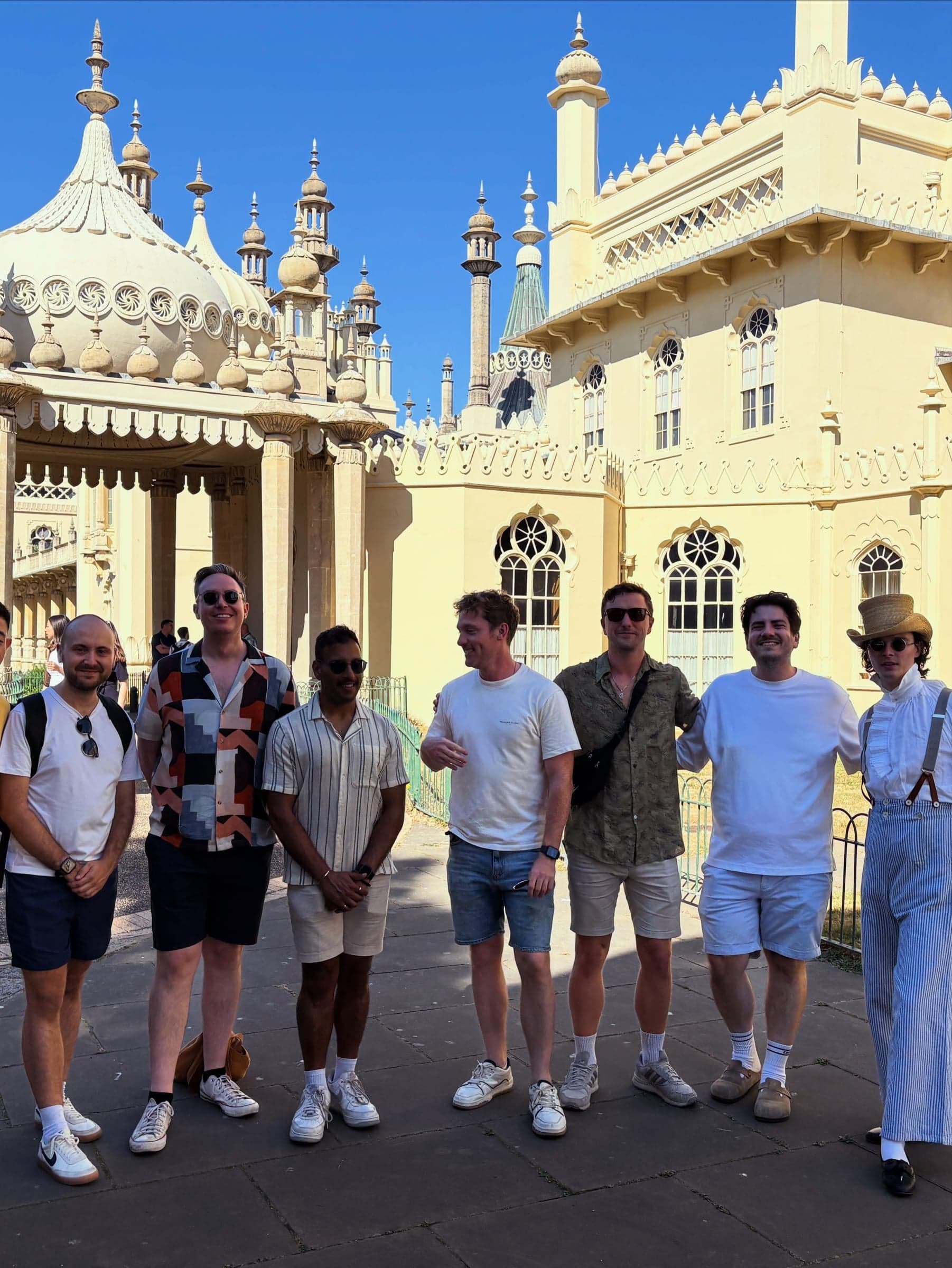 Group photo in front of an ornate domed pavilion.