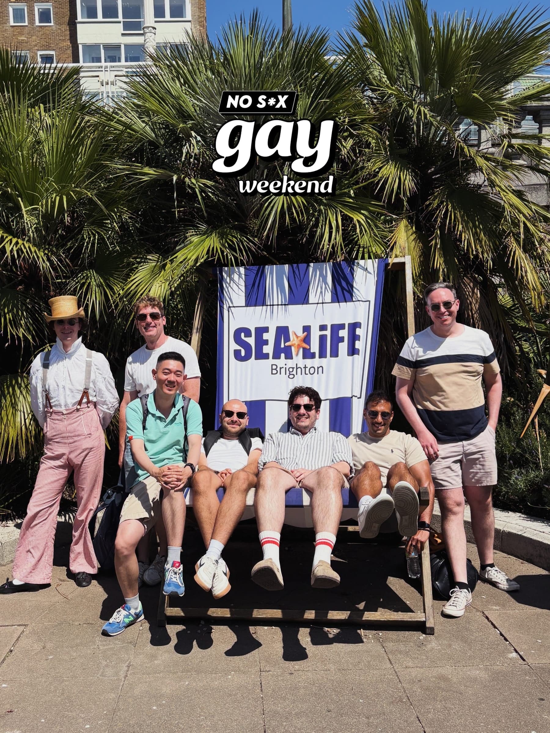 Group posed beneath the weekend's sign outside an aquarium.