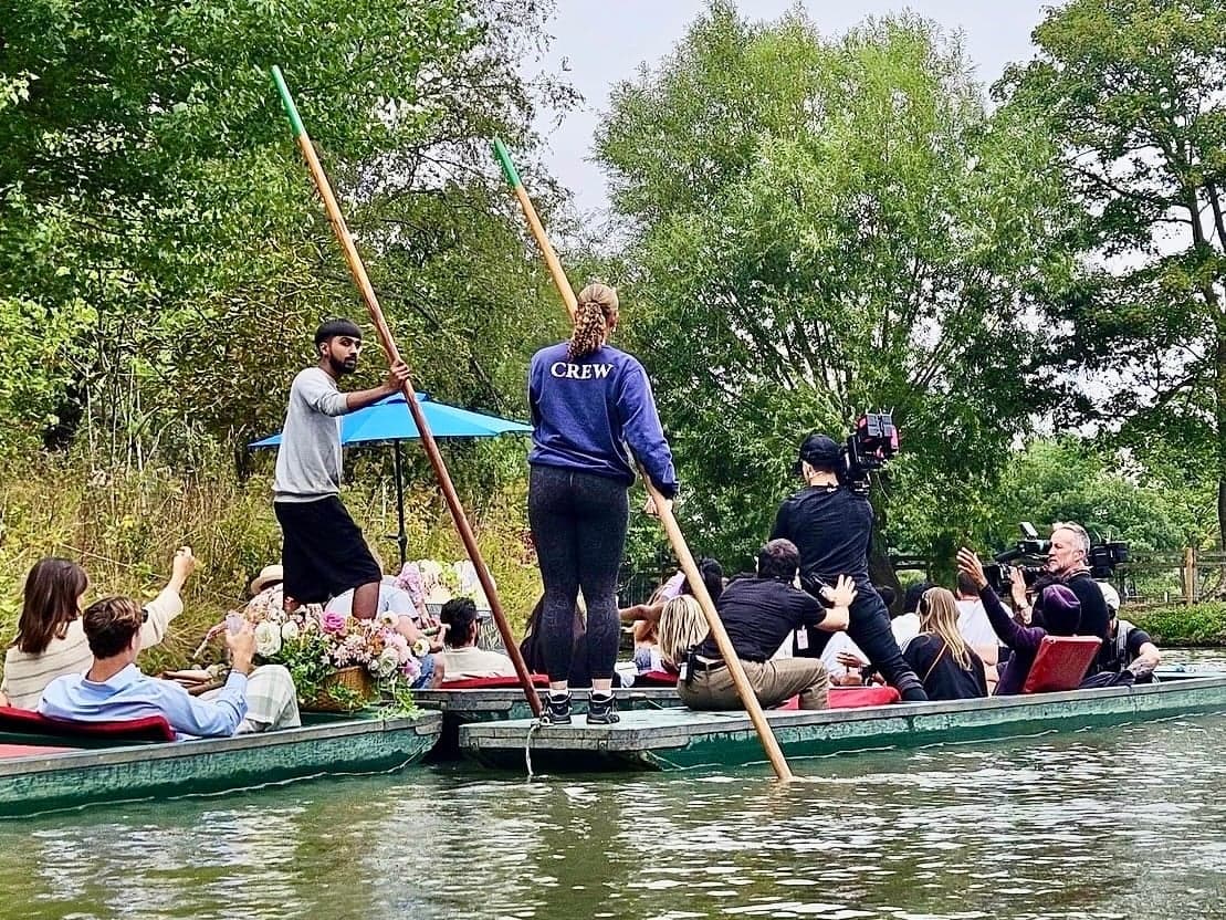 Punts setting off under the trees